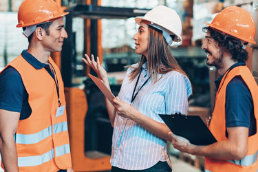 People in hardhats and hi-vis talking