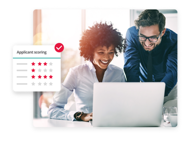 Two HR professionals reviewing the applicant scoring feature on PeopleHR’s recruitment management software.
