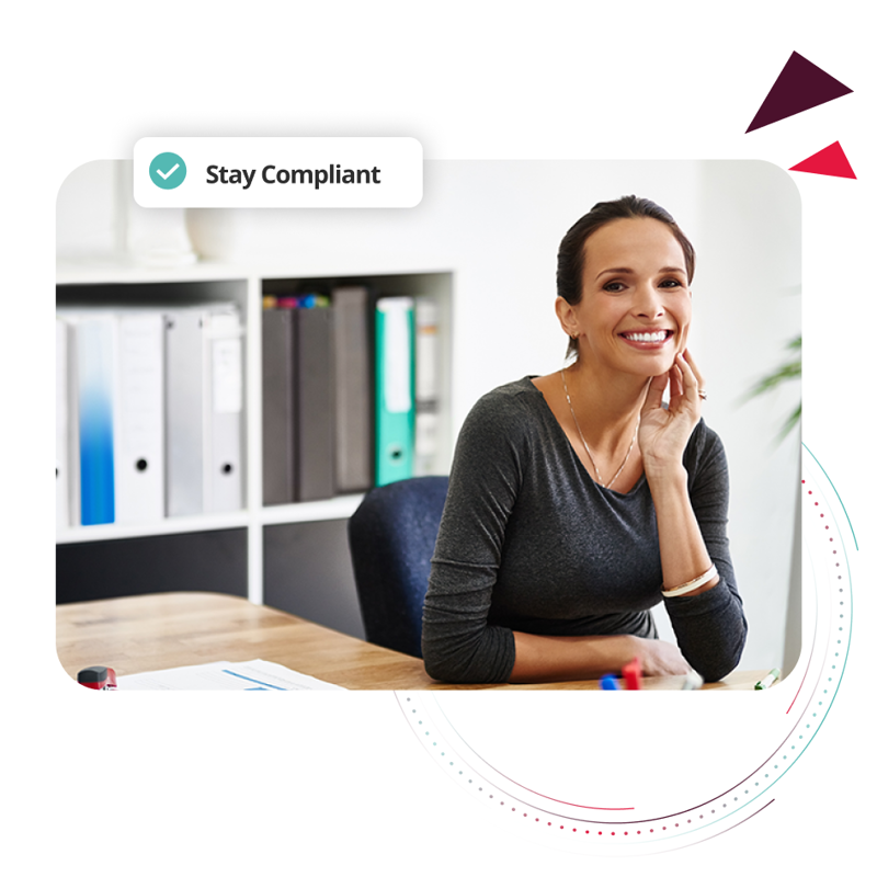 Woman working at desk ensuring payroll compliance.