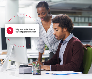 Employees discussing the expansion of payroll services