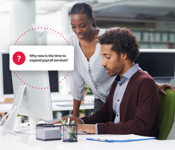 Employees discussing the expansion of payroll services