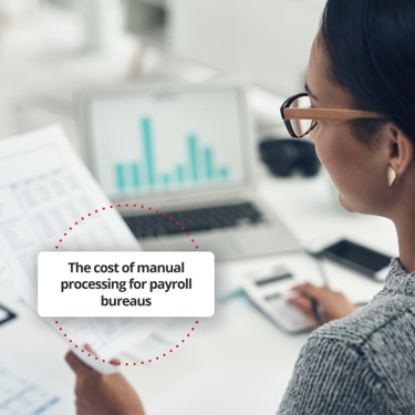 Employee managing payroll manually in office setting.